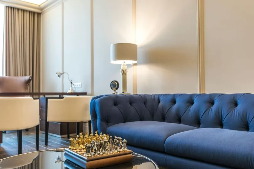 Freshly cleaned blue tufted upholstered sofa in a bright living room